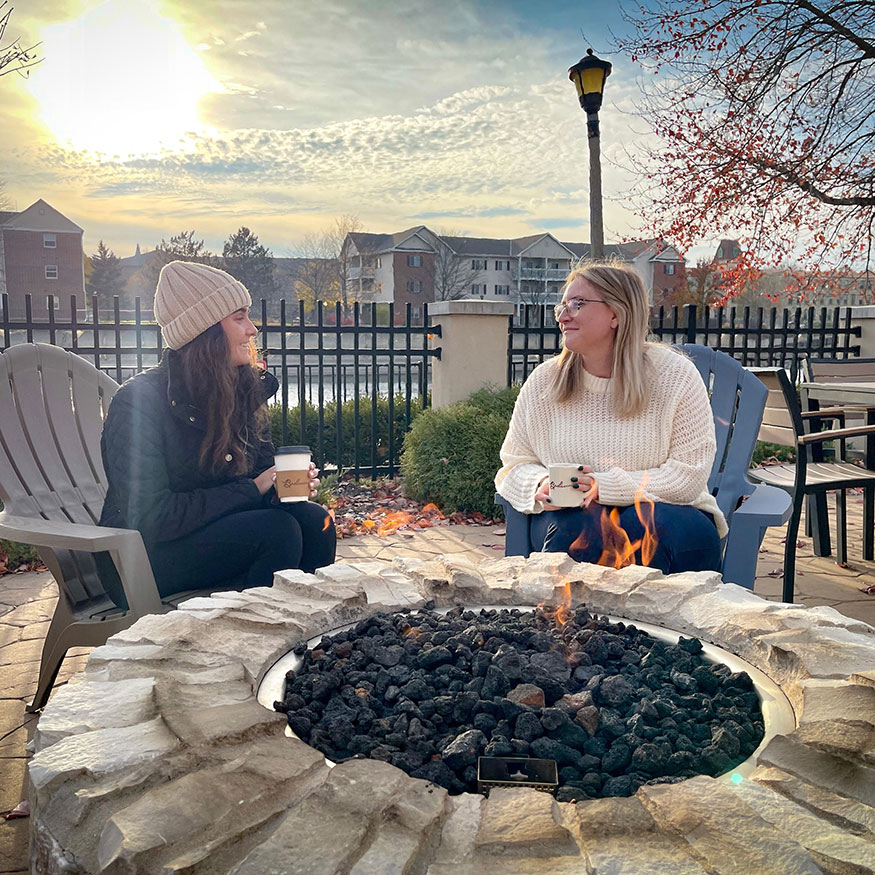 Women Sitting Around The Fire